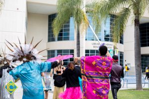 Dancers in the Mardi Gras parade heading to the Library & Learning Resource Center.