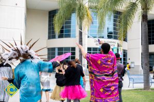 Dancers in the Mardi Gras parade heading to the Library & Learning Resource Center.