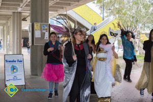 Students and staff walking in Mardi Gras parade.