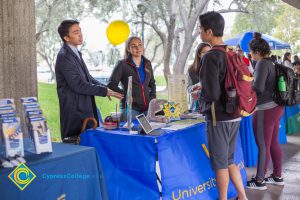 Students talking to representatives of UC and Cal State Universities.