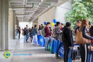 Students talking to representatives of UC and Cal State Universities.