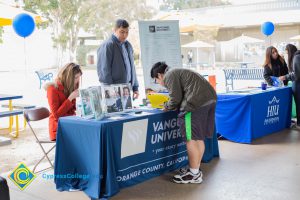 Students talking to representatives of UC and Cal State Universities.