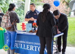 Students talking to representatives of UC and Cal State Universities.