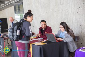 Students talking to representatives of UC and Cal State Universities.