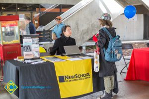 Students talking to representatives of UC and Cal State Universities.