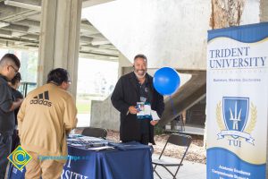 Students talking to representatives of UC and Cal State Universities.