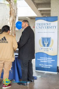 Students talking to representatives of UC and Cal State Universities.