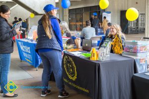 Students talking to representatives of UC and Cal State Universities.