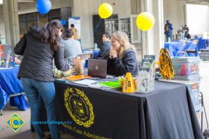 Students talking to representatives of UC and Cal State Universities.