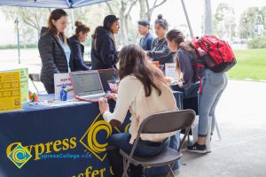 Students talking to representatives of UC and Cal State Universities.