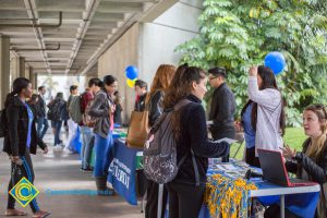 Students talking to representatives of UC and Cal State Universities.