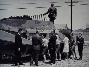 People posing with construction equipment