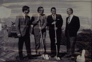 People posing with shovels