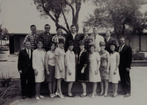 Black and white photo of a group of men and women