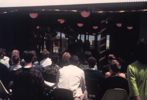 Early photograph of campus with students playing music