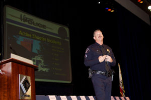 Cypress Police Department Lead Police Officer Michael Wintersole, a first responder to the 2011 Salon Meritage shooting, addresses Cypress College employees about how to react in an active-shooter scenario.