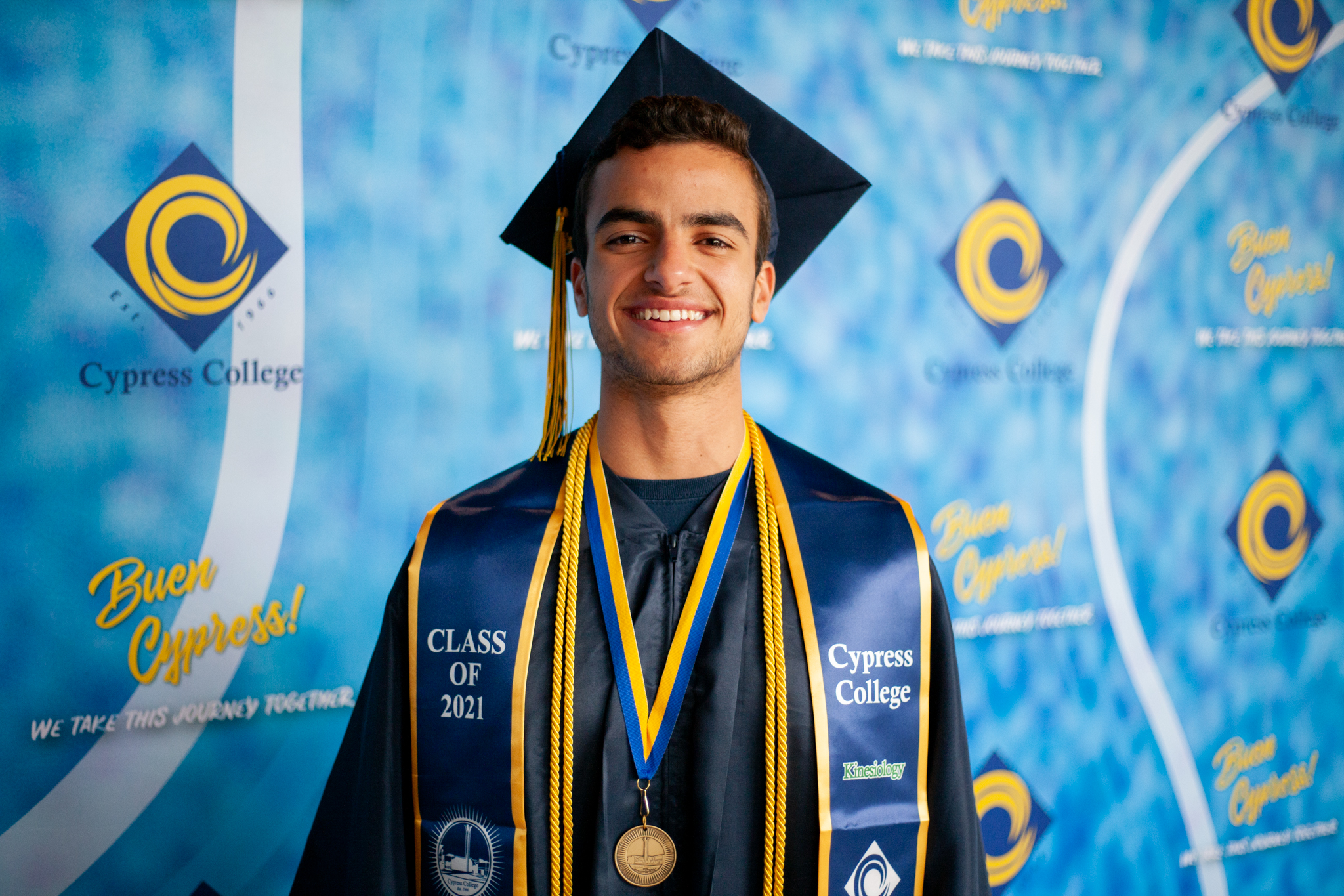 Kinesiology Presidential Scholar of Distinction Jonathan Gad poses in front of blue wall.