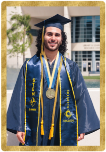 Student Justin Urquilla poses in front of library wearing Cypress College graduation regalia.