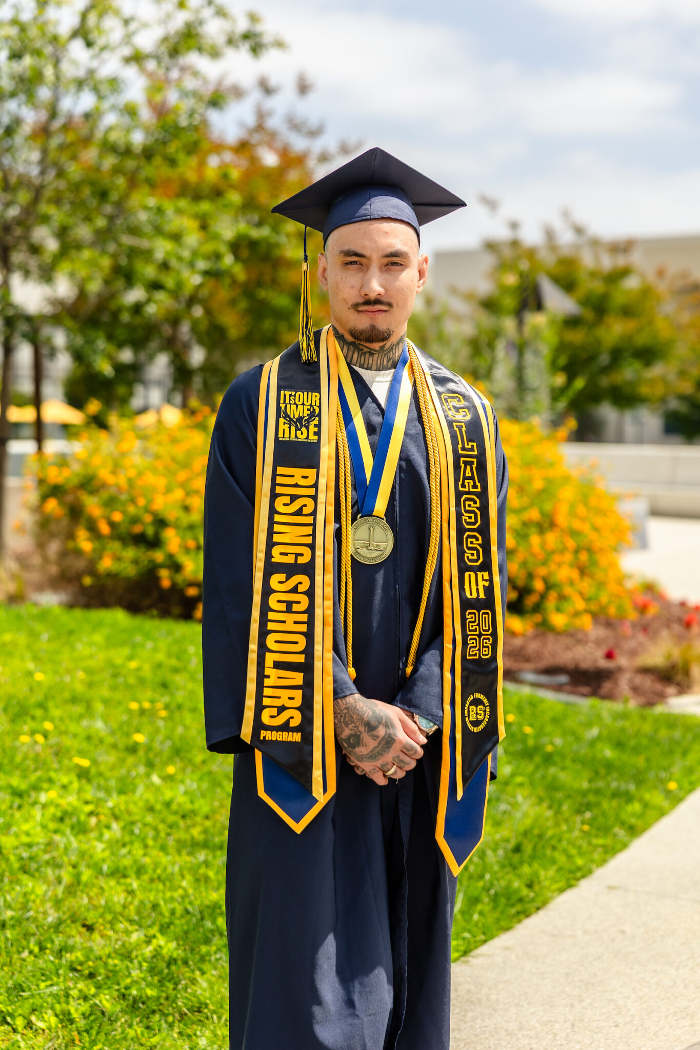 Outstanding Graduate of the Year Huey Hoang in graduation regalia