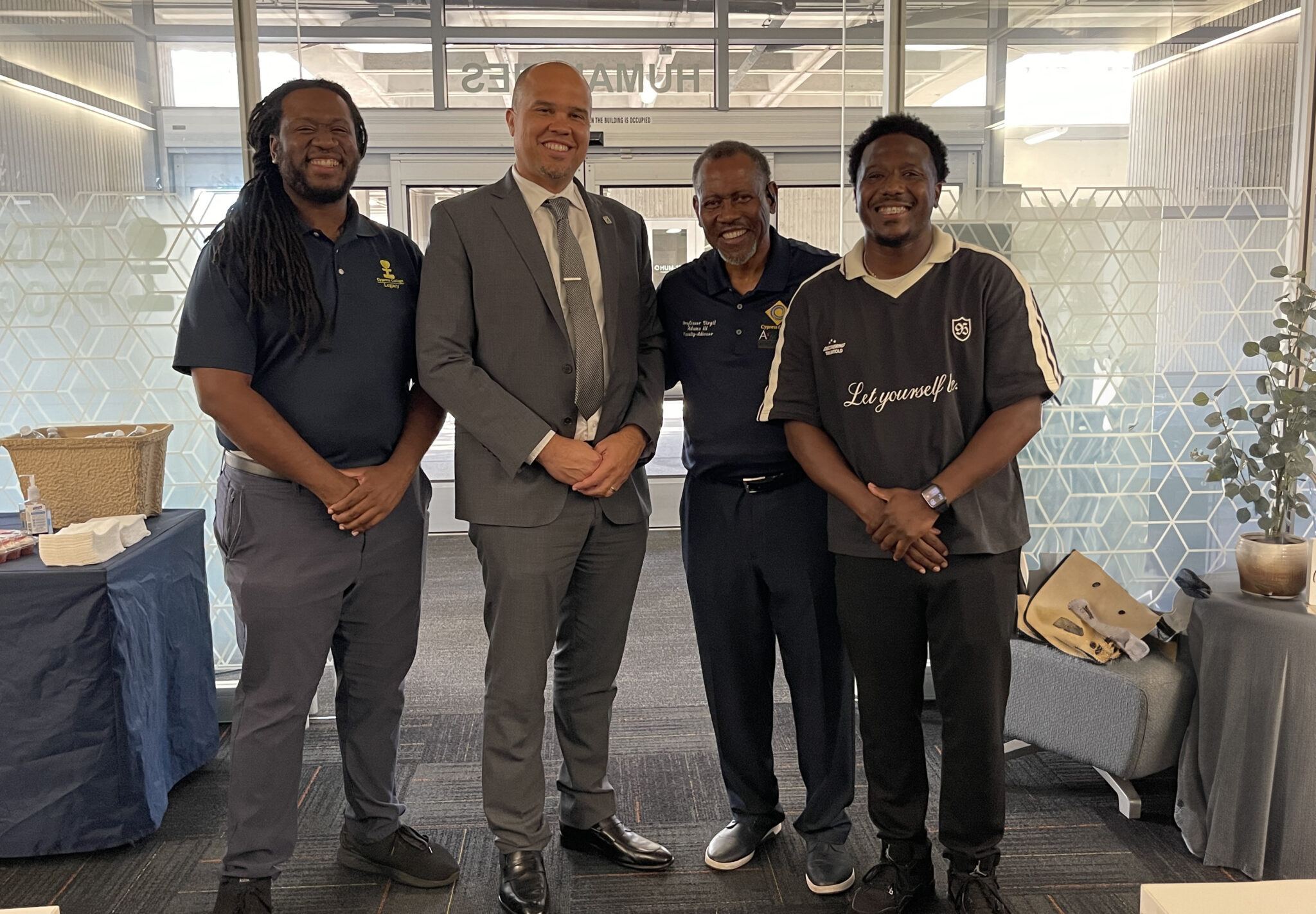 Four Black men pose in a student center as part of the A2MEND leadership team