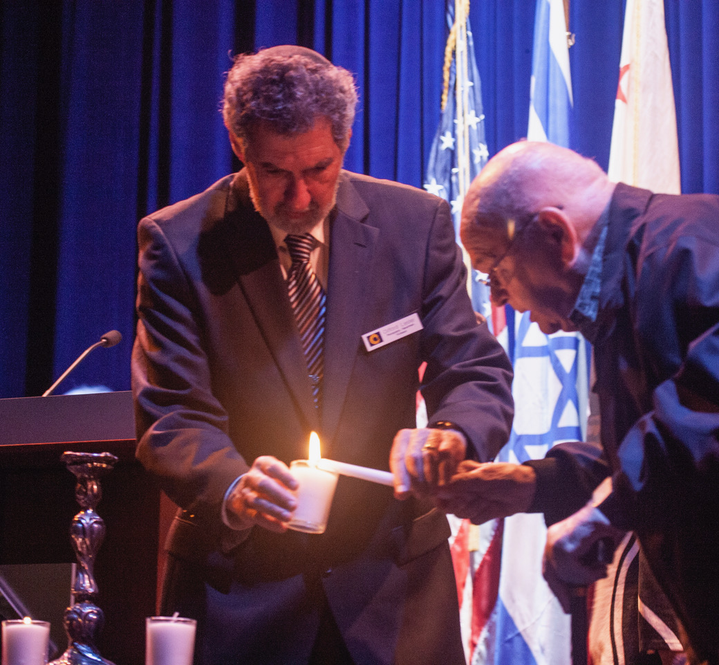 Clifford Lester joins Holocaust Survivor Dr. Edgar Moran in lighting memorial candles for the victims of the Holocaust.
