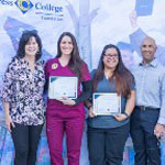 Four smiling people at scholarship reception.