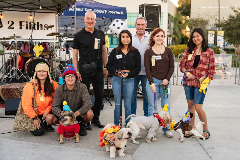 Cypress College Foundation board member Curtis Scheetz and City of Cypress Mayor Scott Minikus, posing with the winners of the Pups N’ Pints costume contest, and their dogs.