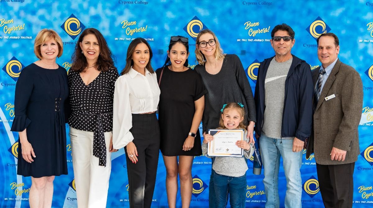 Cypress College President Dr. Joanna Schilling (left), Cypress College Foundation Board President Kenneth Vecchiarelli (right), scholarship recipients and family at the 2023 Scholarship Awards Ceremony