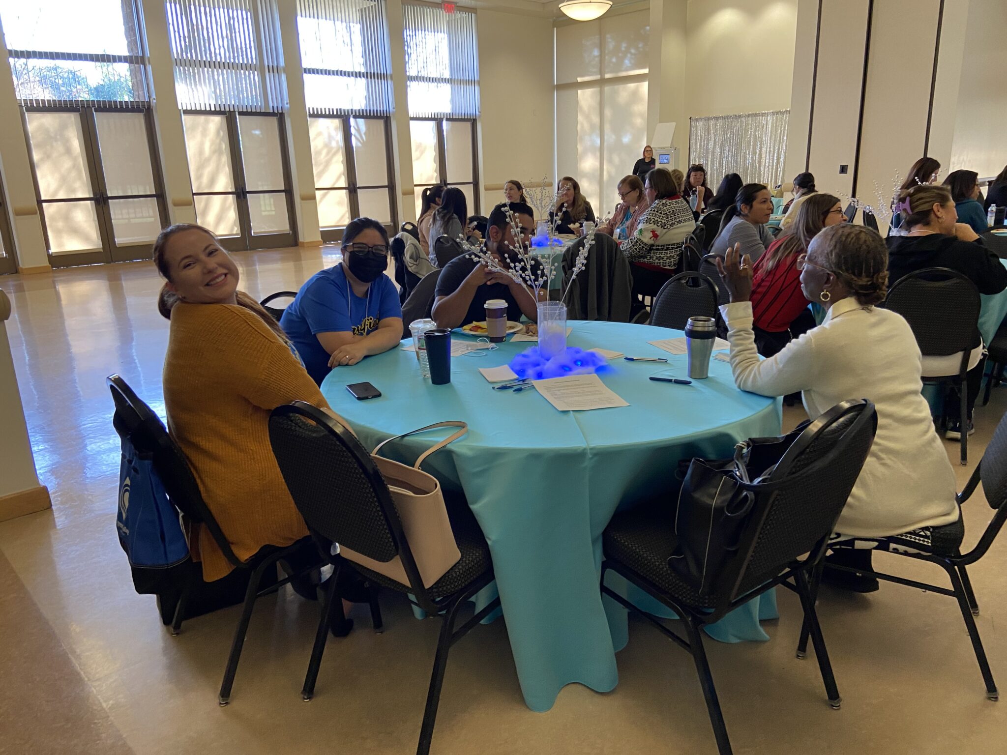 Classified staff pose for a photo at their round table.