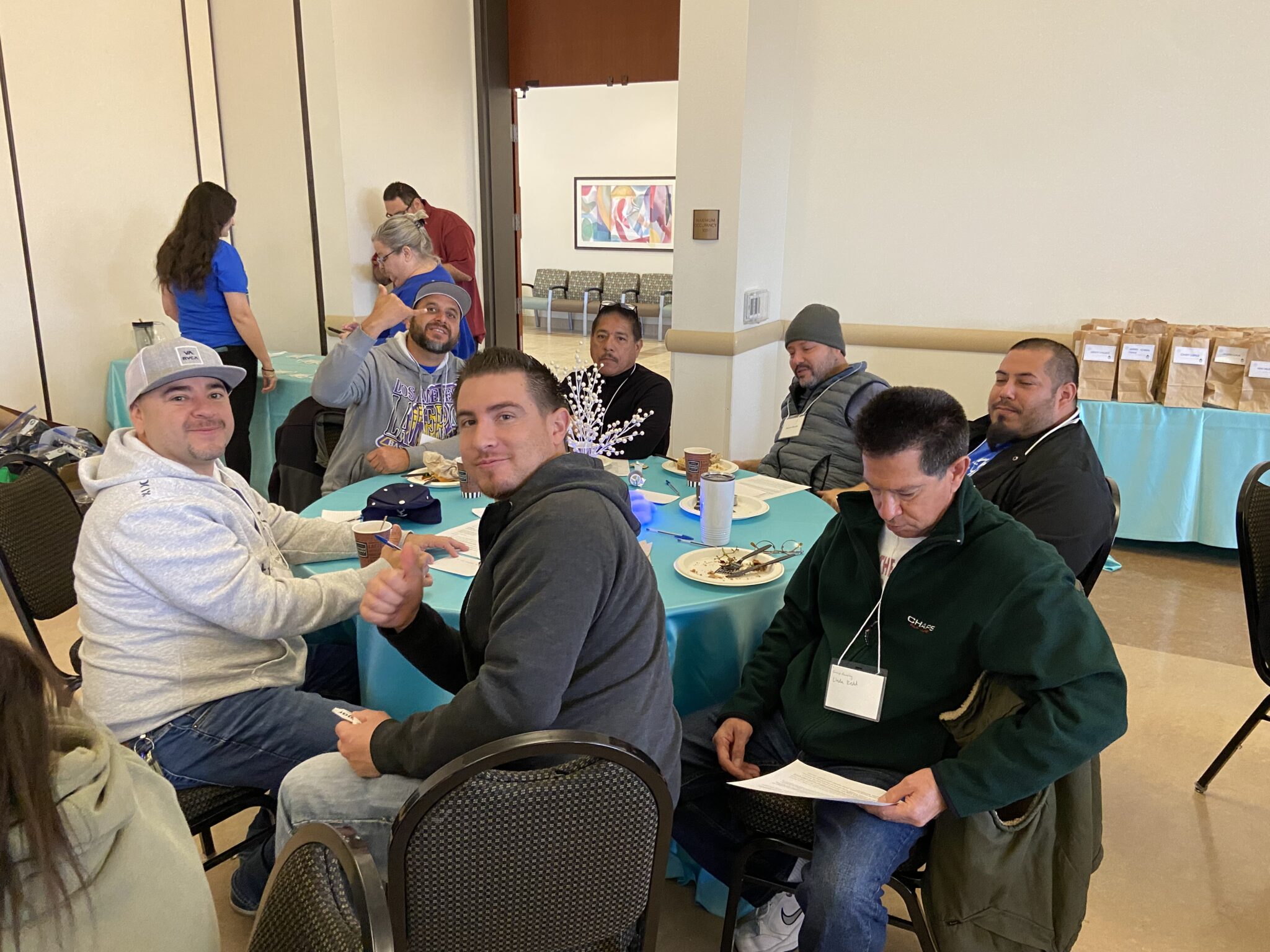 A group of classified staff posing for a photo at their table.