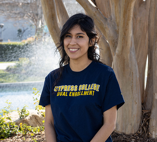 Dual Enrollment staff Andrea Laguna Morales smiling with pond in background