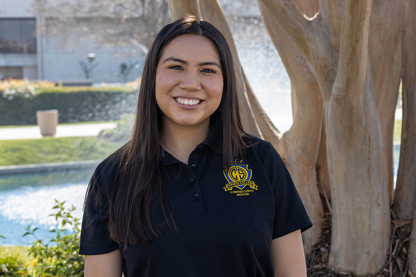 Dual Enrollment staff Daniela Juarez-Valencia smiling with pond in background