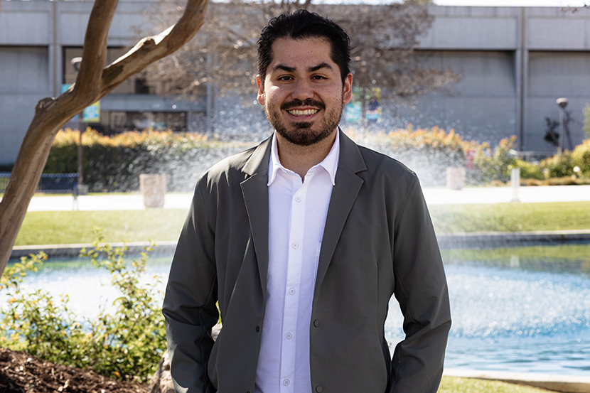 Dual Enrollment staff David Rodriguez smiling with pond in background