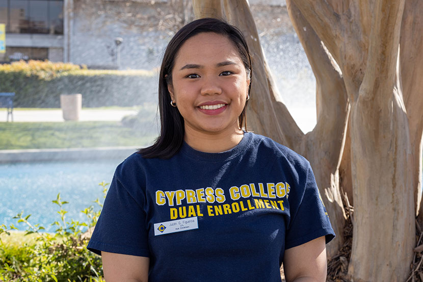 Dual Enrollment staff Justin Figueroa smiling with pond in background