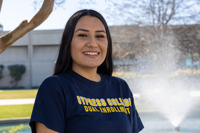 Dual Enrollment staff Kassandra Rojas smiling with pond in background