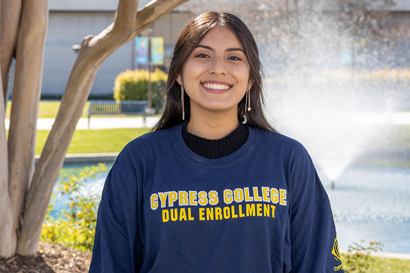 Dual Enrollment staff Luz Vazquez smiling with pond in background