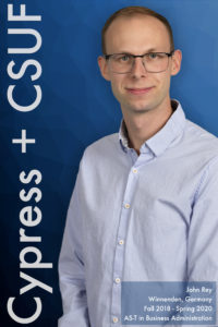 Man in blue shirt wearing glasses