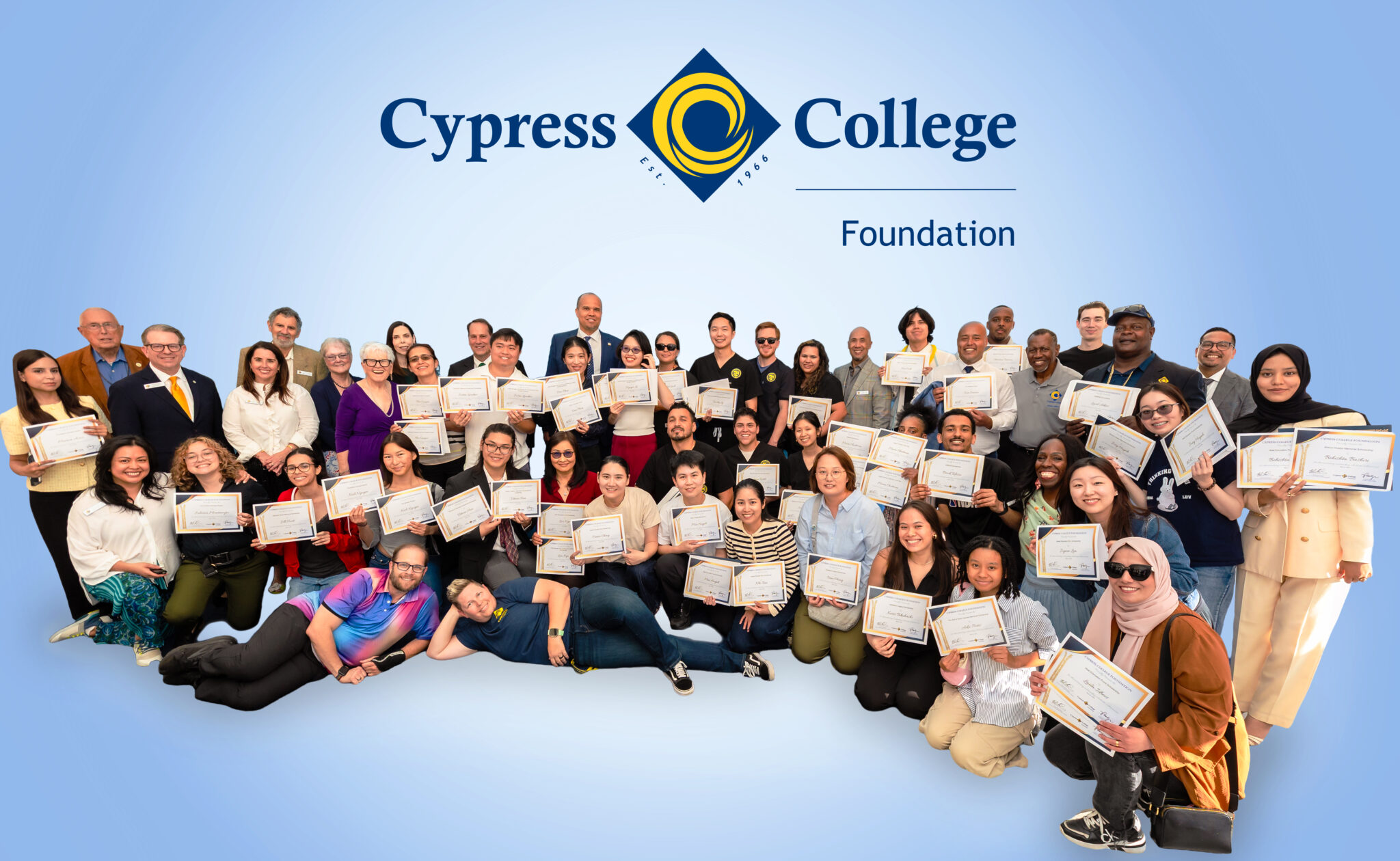Students and staff pose with scholarship award certificates.