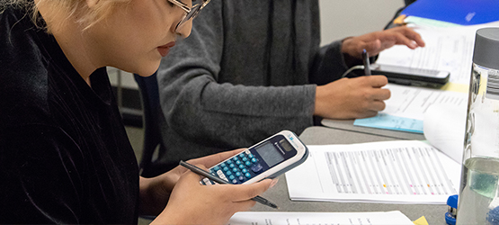 Student working with a calculator