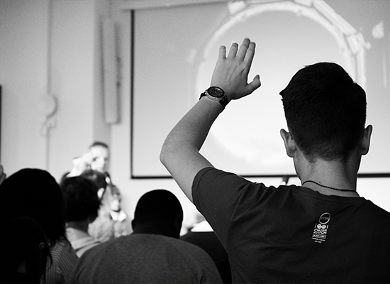 Student raising hand in class