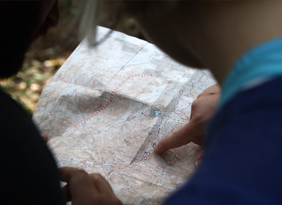 People looking at and pointing to a map