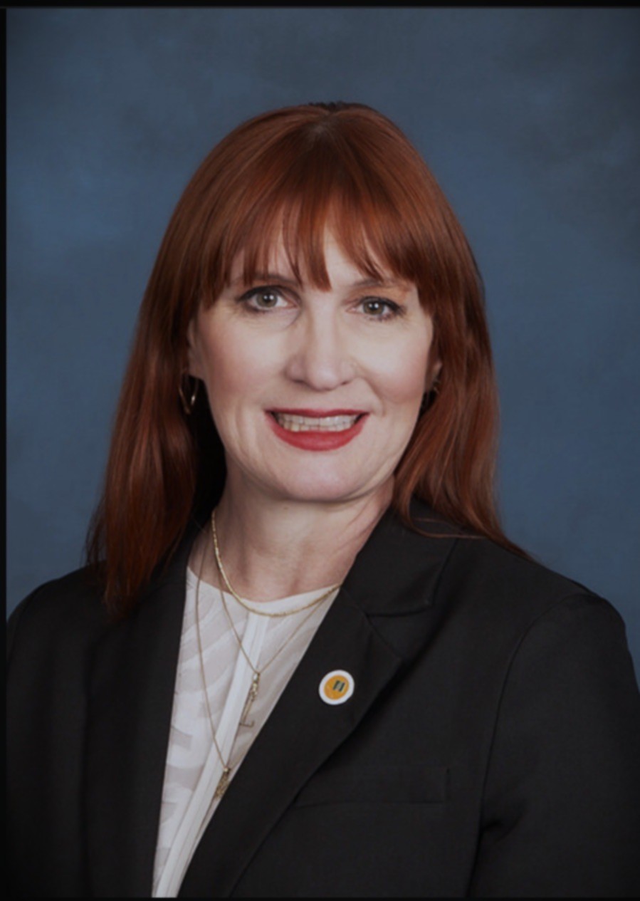 Headshot of Professor Lori Collins wearing a dark jacket and white blouse