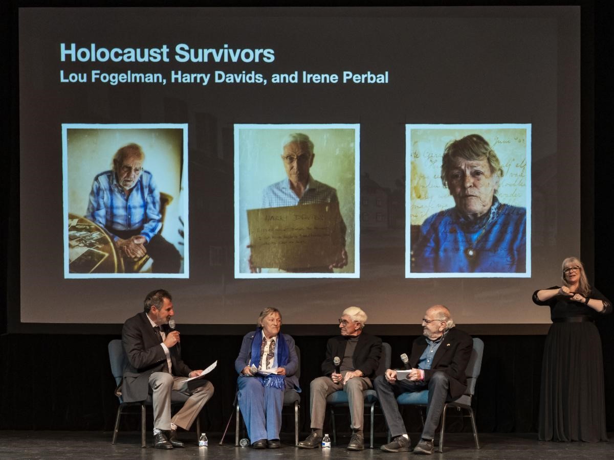 Cliff Lester interviewing Lou Fogelman, Harry Davids, and Irene Perbal on stage.