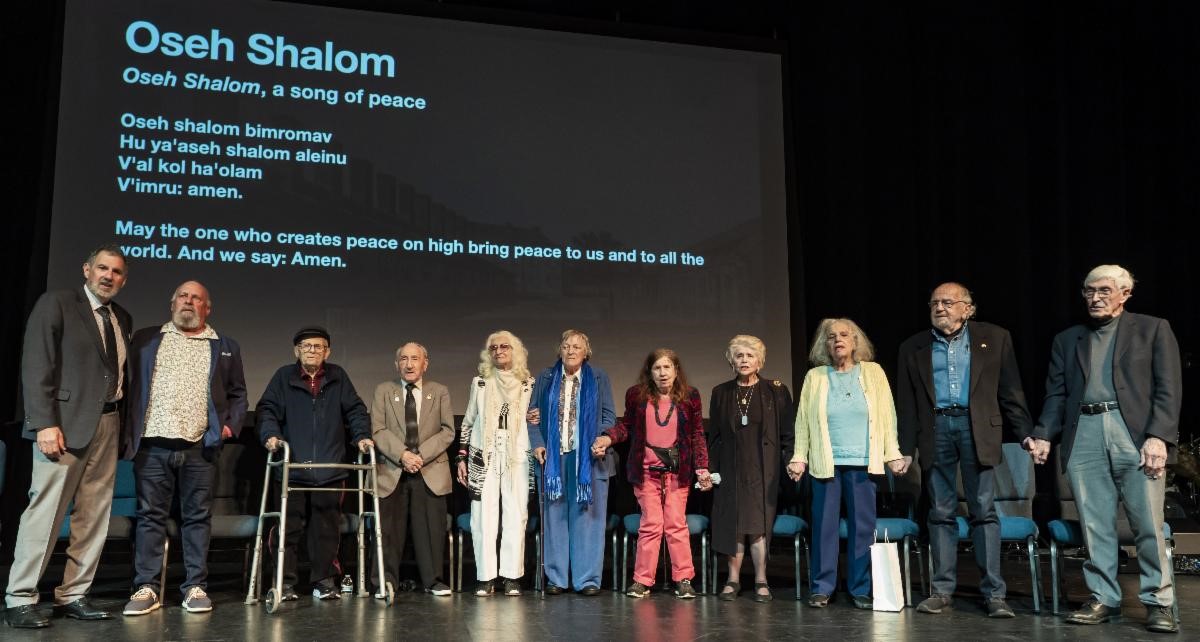 A standing group photo of all the interviewees and Cliff Lester.