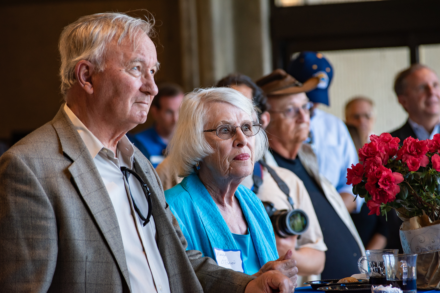 An audience watches a speaker