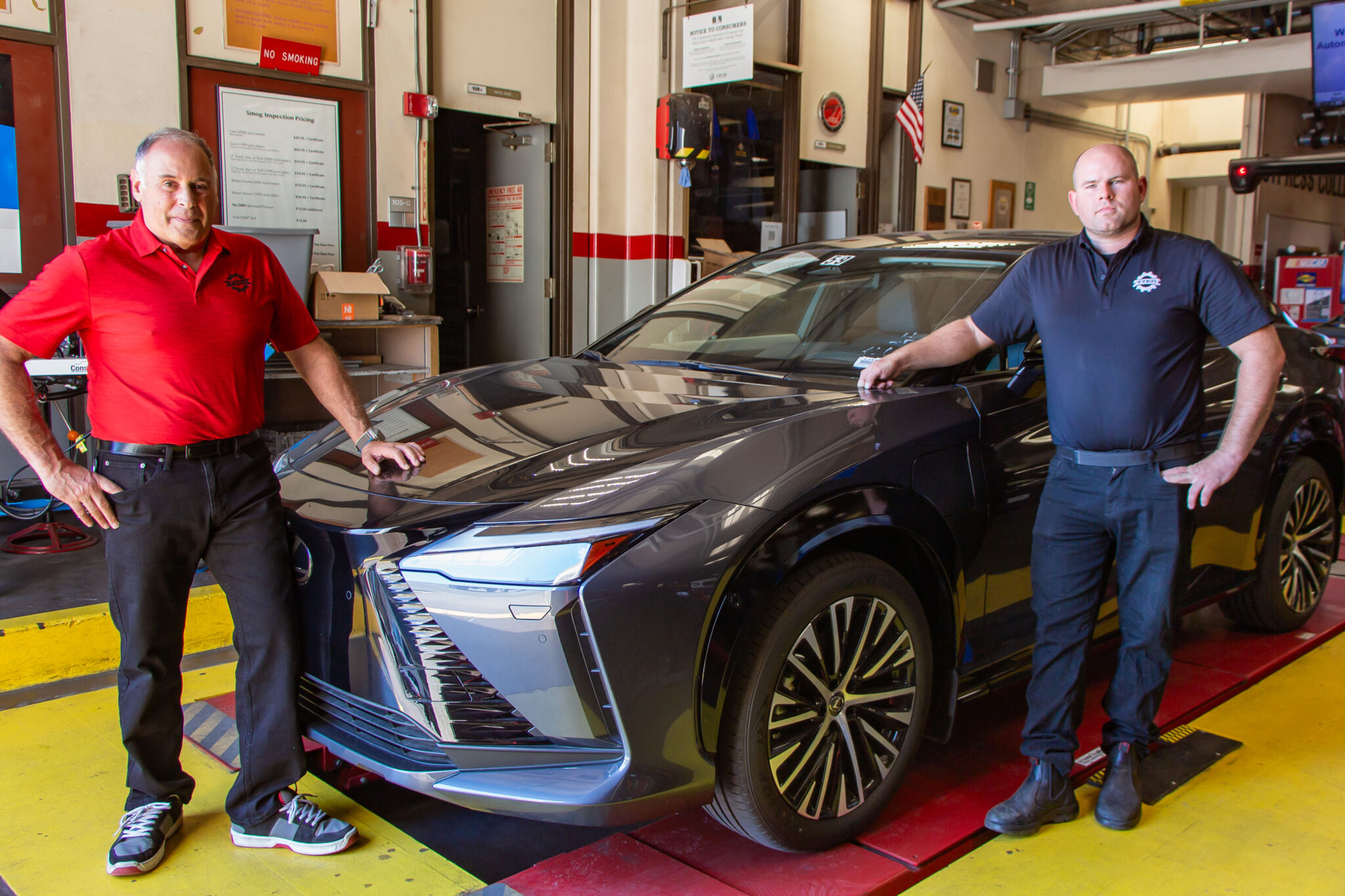 Toyota T-TEN director Michael Klyde and T-TEN instructor Paul Kelley stand by a Lexus EV.
