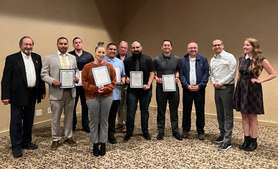 A group of 12 people, including Air Conditioning and Refrigeration students, pose with recent scholarship certificates.