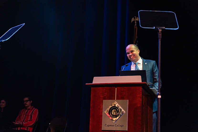 Dr. Scott Thayer smiling at podium