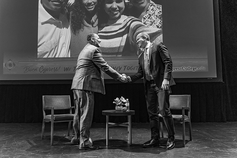 Marc Posner and Dr. Scott Thayer shaking hands on stage