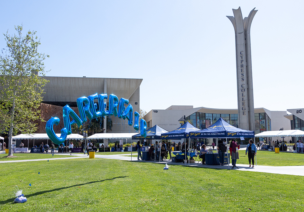 Balloons spell out "Career Fair" in front of the campanile on campus.